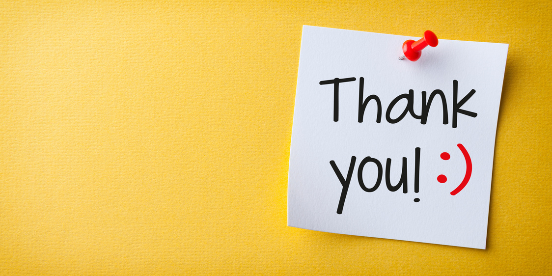White Sticky Note With Thank You And Red Push Pin On Yellow Background